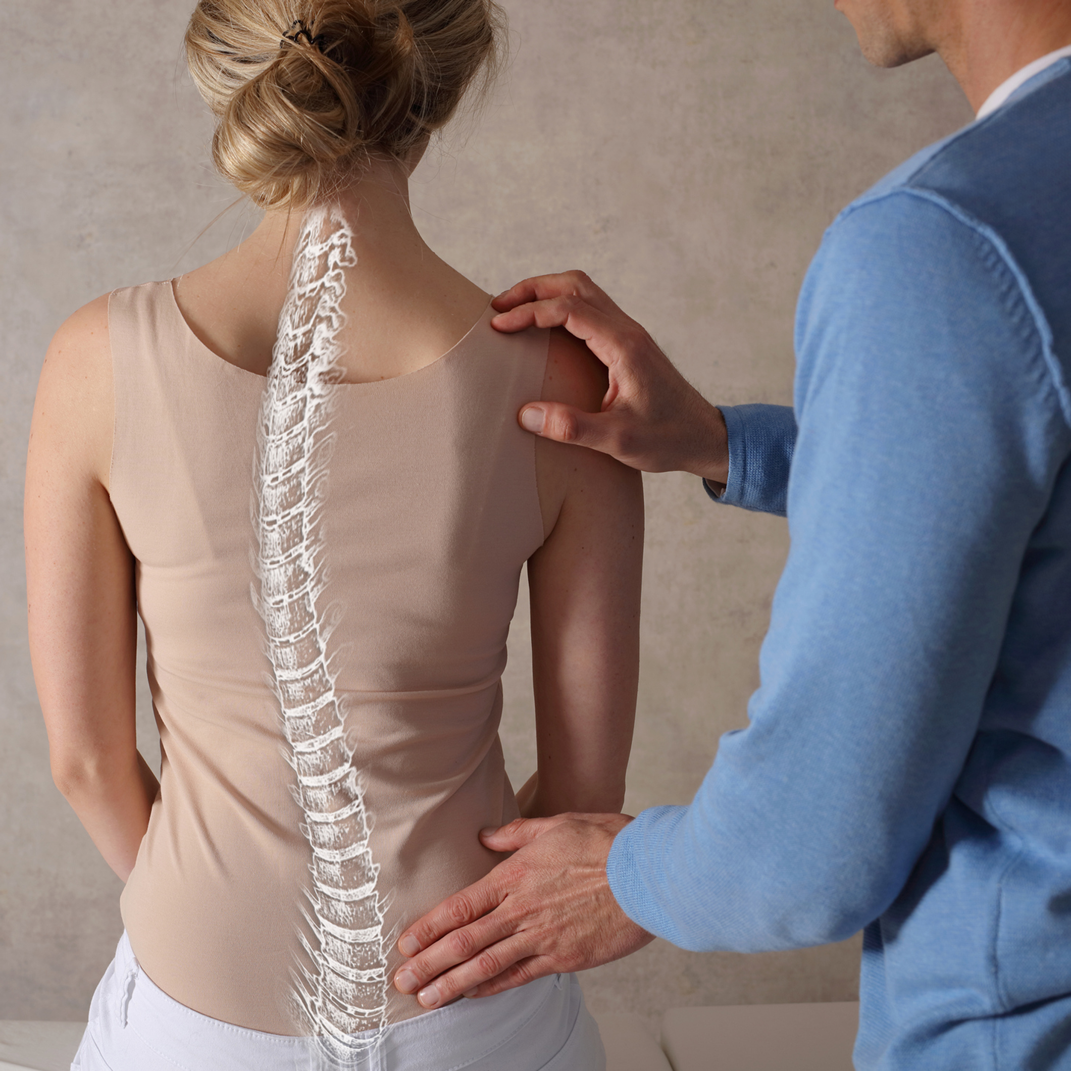 Chiropractor assessing patient's spine alignment