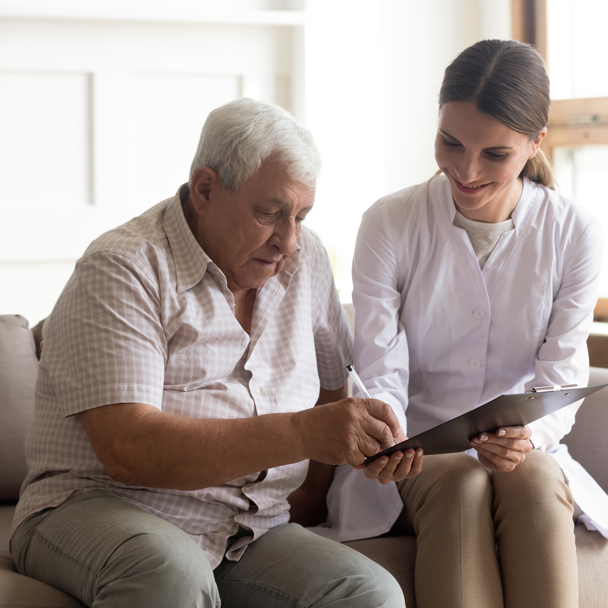 Healthcare professional assisting elderly patient