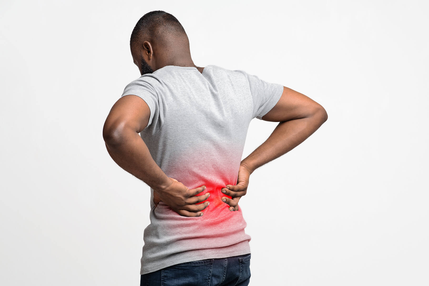 Man with back pain holding lower back