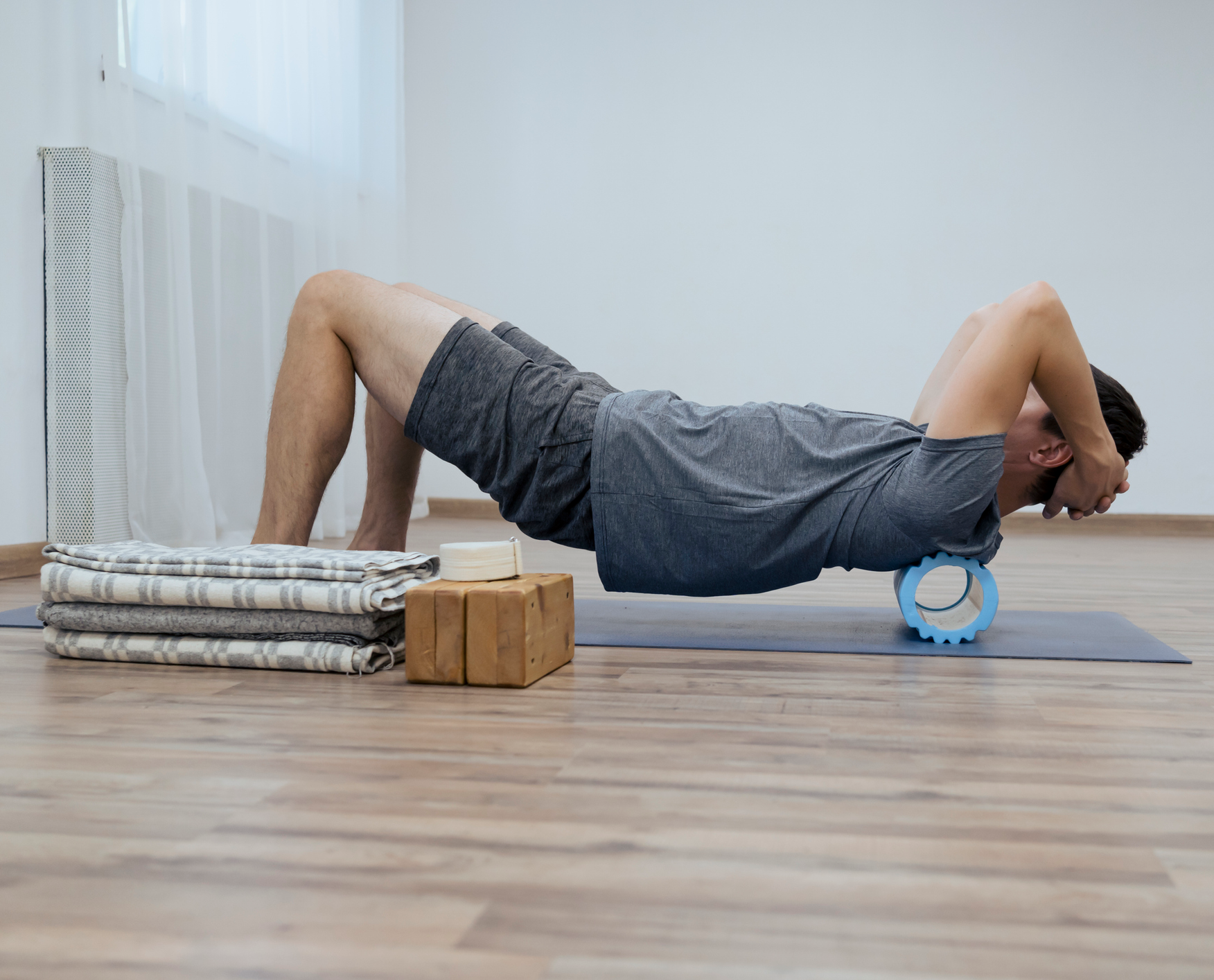 Man using foam roller for back stretch