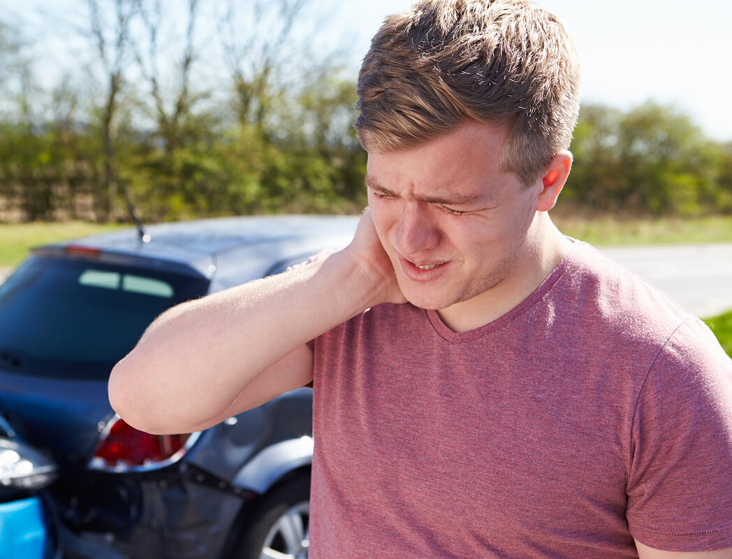 Individual experiencing discomfort post-collision