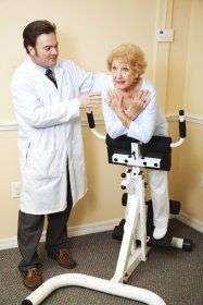 Elderly woman exercising with doctor's help