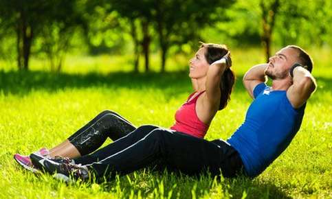 Couple exercising on grass