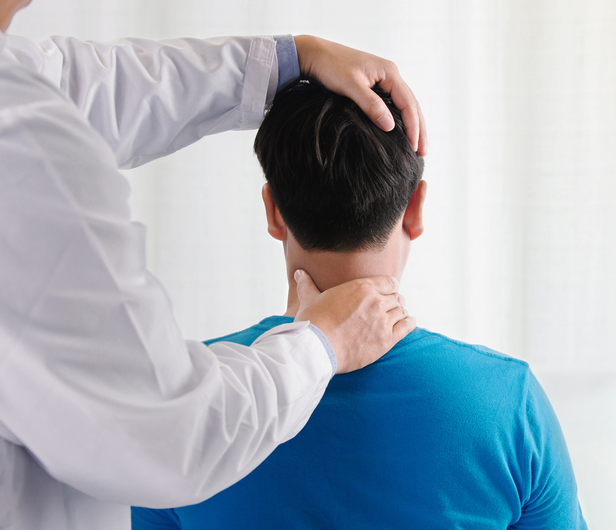 Doctor examining patient's neck