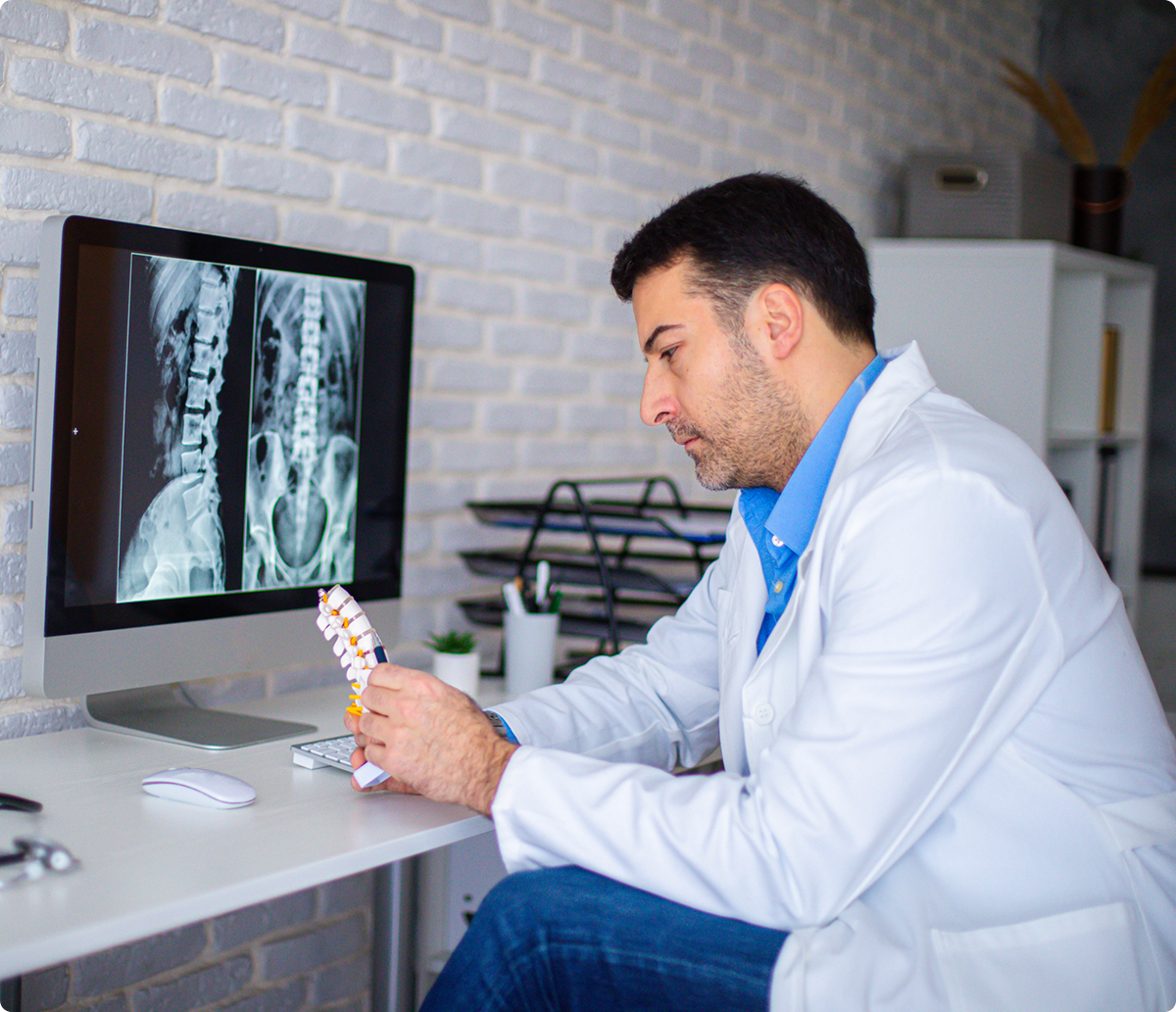 Physician reviewing spinal X-ray images
