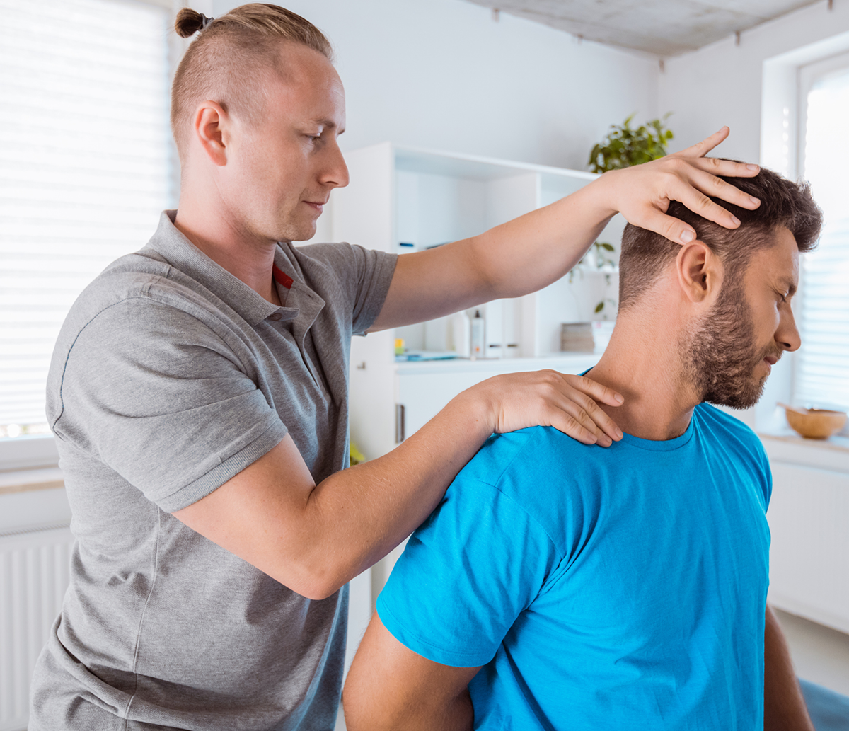 Man receiving neck adjustment therapy