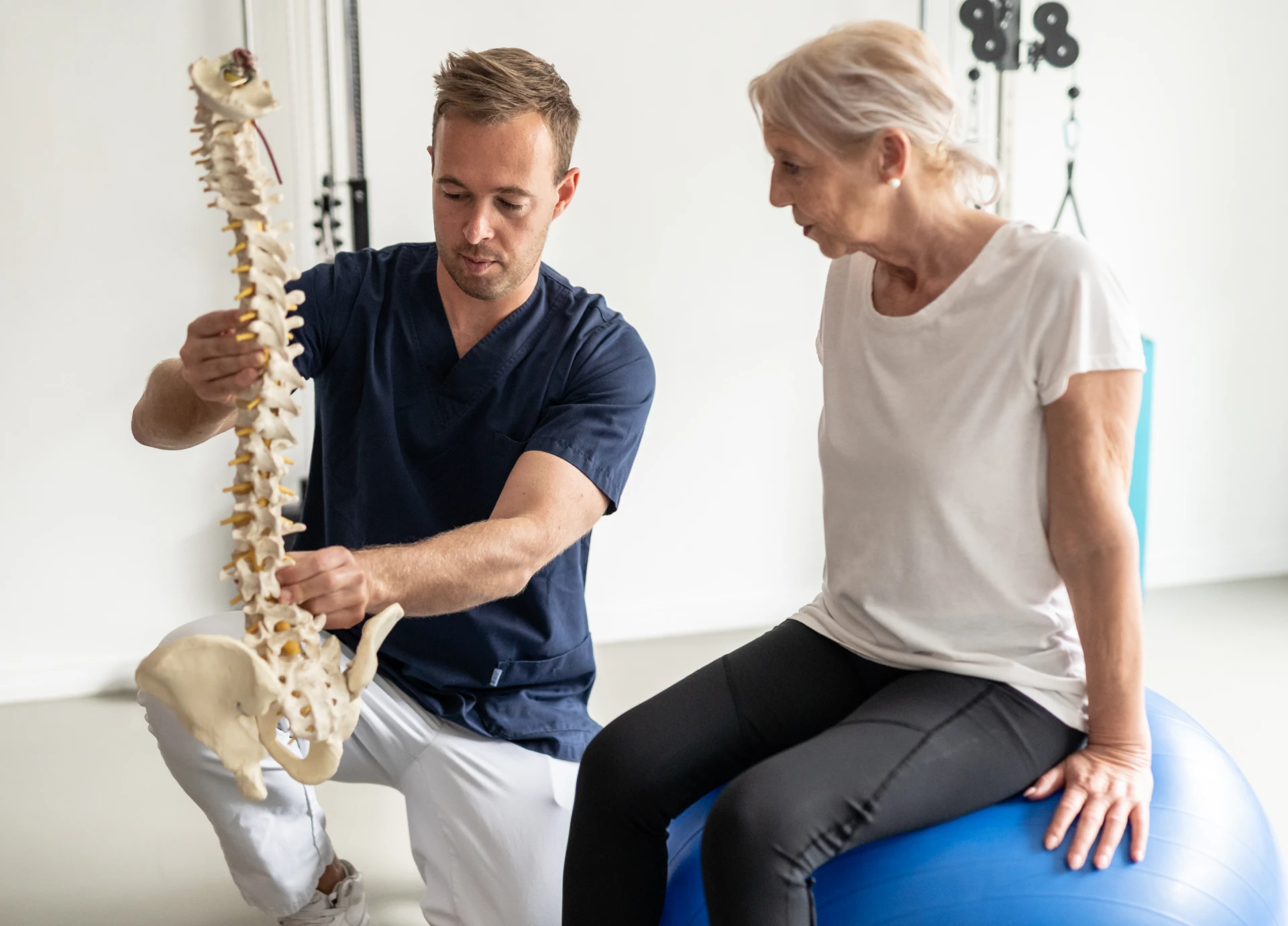Physical therapist explaining spine model