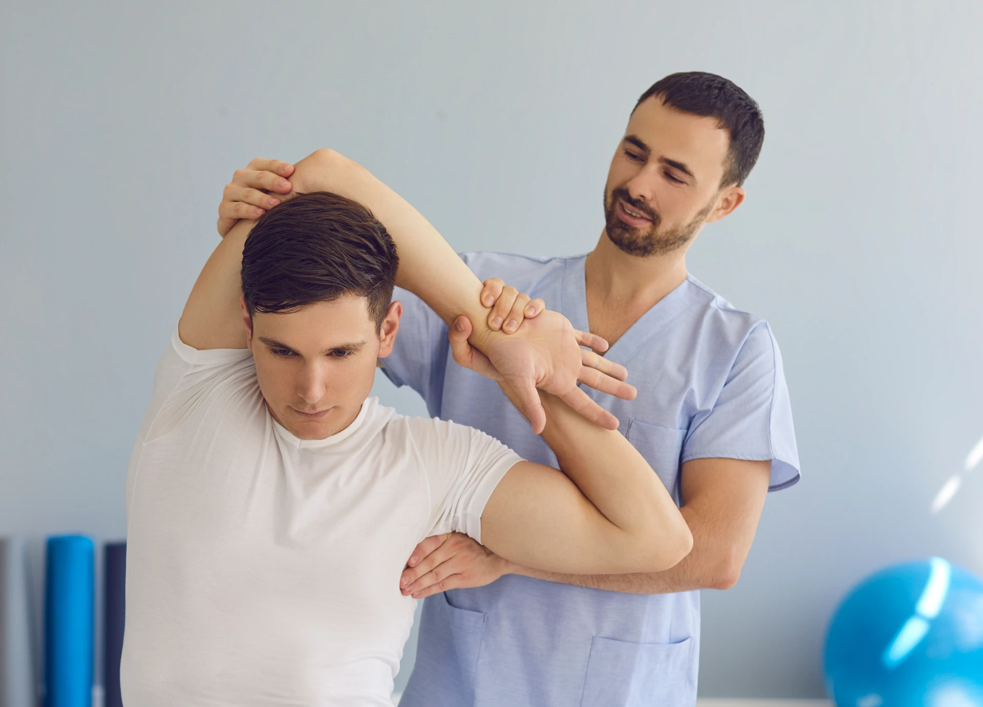 Therapist helping patient with arm exercise