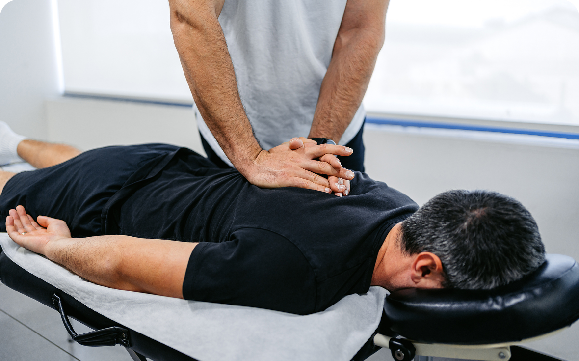 Chiropractor performing spinal adjustment
