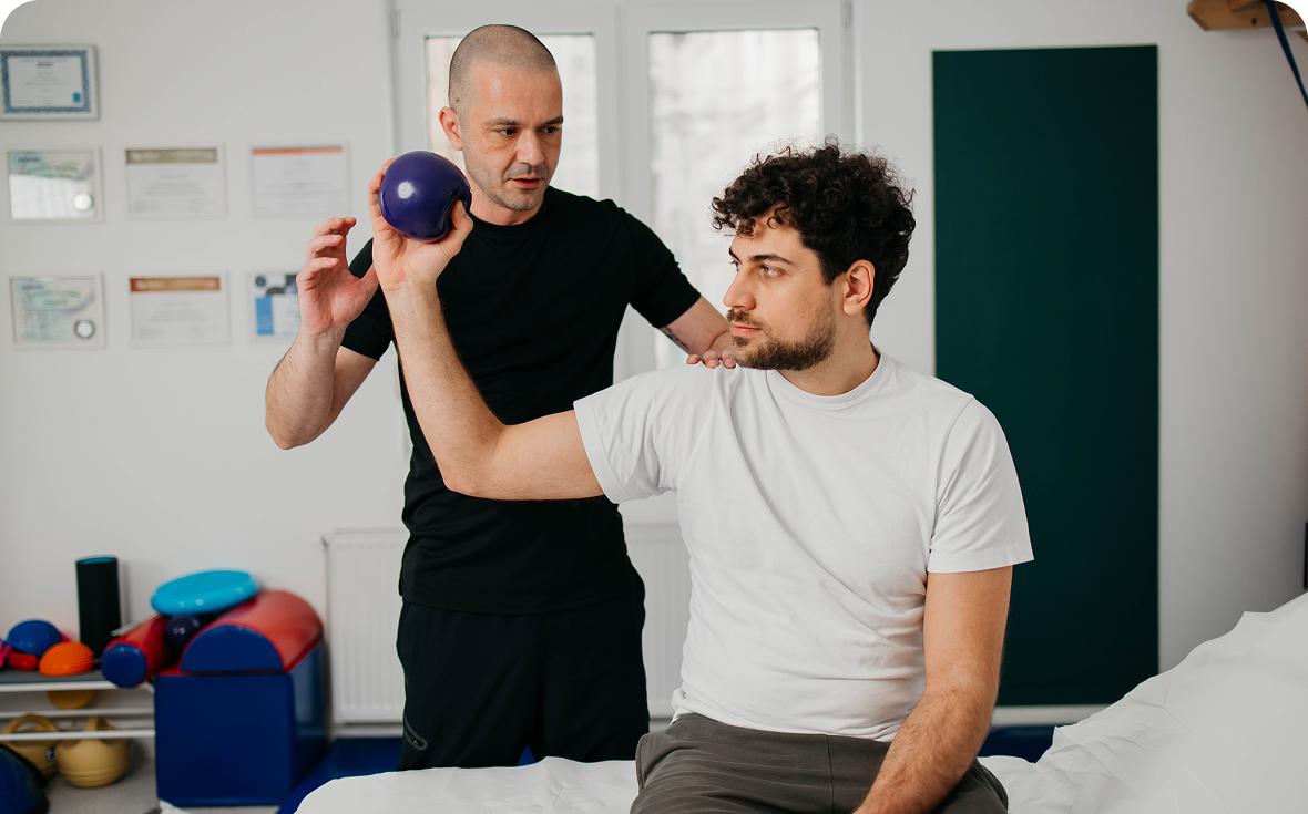 Therapist guiding patient with exercise ball