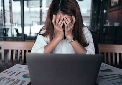Stressed woman at laptop