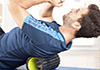 Exercising with foam roller on mat