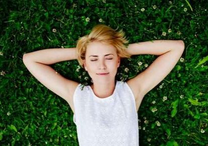 Woman relaxing on green grass
