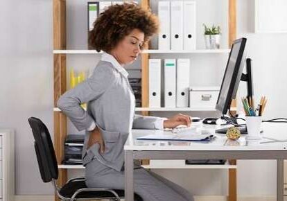 Employee holding back in office chair