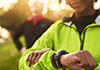 Woman in green jacket with smartwatch