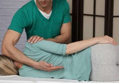 Chiropractor adjusting patient's back