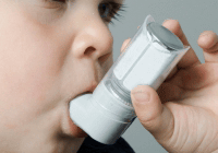 Young boy inhaling medicine