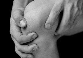 Grasping knee in discomfort