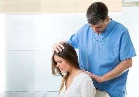 Healthcare professional treating woman's spine