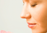 Woman smelling a pink rose