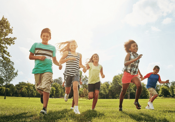 Group of kids sprinting on grass