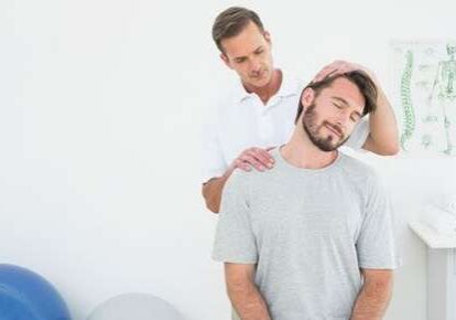 Man receiving neck treatment in clinic
