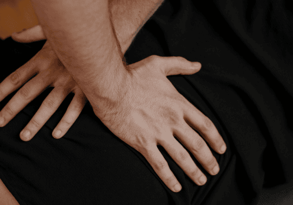 Therapeutic hands on a person's back