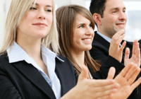 Business professionals applauding enthusiastically