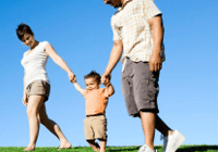 Happy family stroll on sunny day.