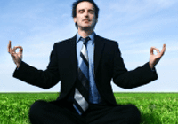 Man in suit practicing yoga outside