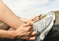 Runner lacing up sneakers