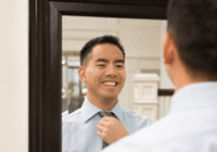Smiling man in mirror reflection