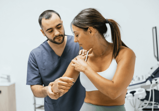 Physical therapist assisting woman with exercise