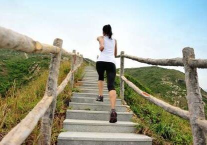 Woman running up outdoor stairs
