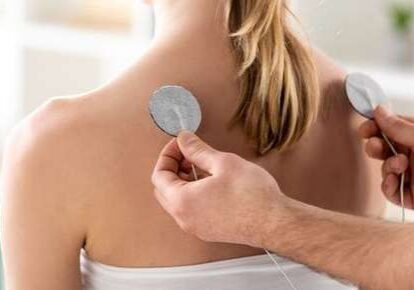 Therapist applying electrode pads