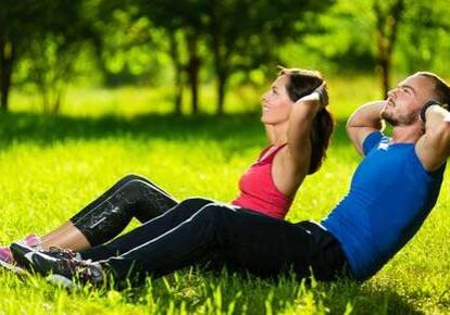 Couple exercising on grass