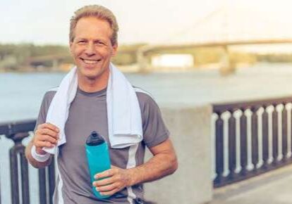 Man jogging with water bottle outdoors