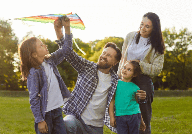 Family flying kite in the park