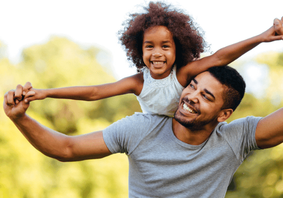 Happy child on dad's shoulders