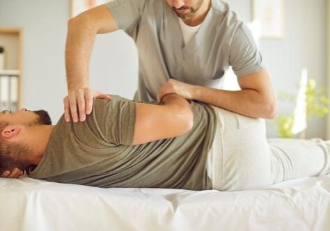 Therapist assisting with back alignment