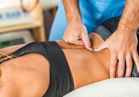 Chiropractor performing back adjustment