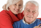 Elderly pair wearing red and blue sweaters
