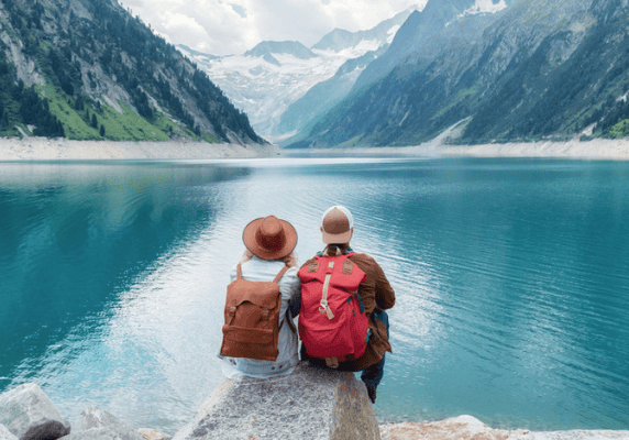 Two hikers overlooking serene lake
