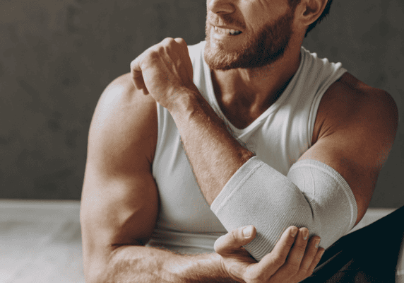 Athletic man adjusting elbow support