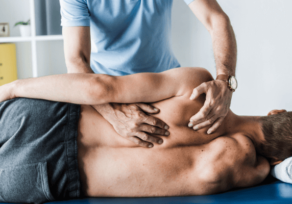 Chiropractor adjusting patient's back