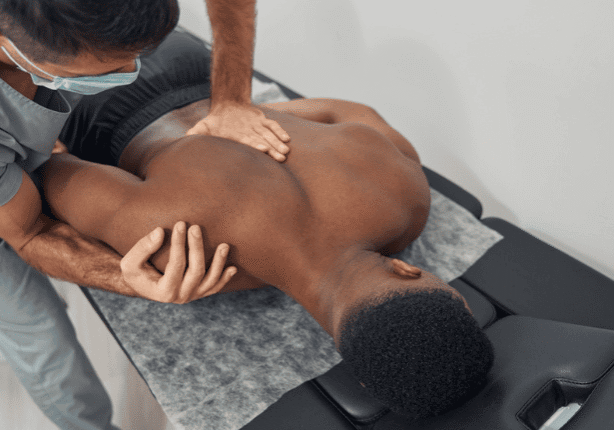 Therapist performing spinal adjustment