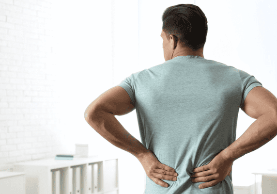 Person with backache indoors