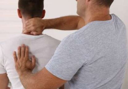 Chiropractor adjusting man's spine