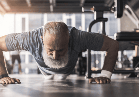 Elderly man exercising indoors