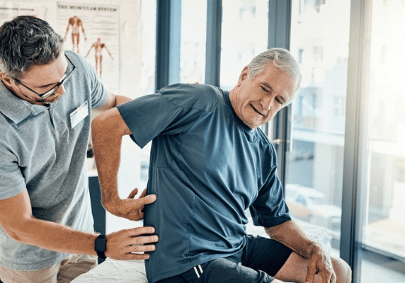 Senior receiving back therapy